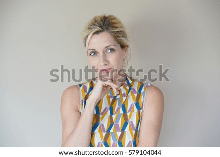 Blond woman expression on beige background, isolated