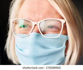 Blond Woman In Foggy Glasses And Antiviral Mask