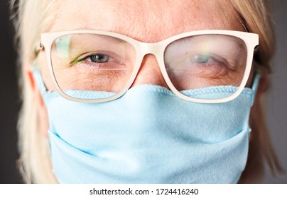 Blond Woman In Foggy Glasses And Antiviral Mask