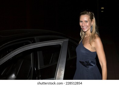 Blond Woman Getting Out Of Her Car In The Night