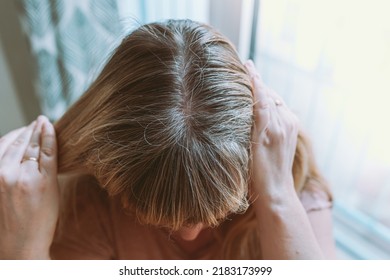 Blond Woman With Gray Hair Requiring Coloring. Close-up Of Woman's Head With Permanent Gray Hair Growing Back Uncolored Hair Roots, High Angle View