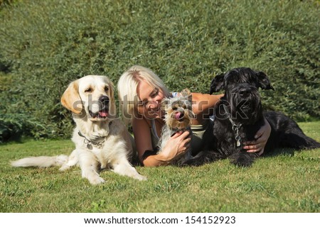 Similar – Image, Stock Photo Blond woman with her two dogs in the countryside