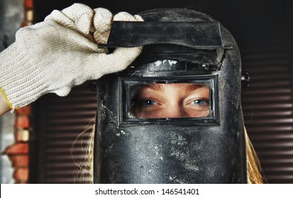 Blond Woman In Overall And Welder Helmet