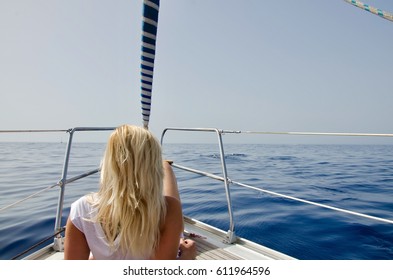 Blond woman relaxing on a boat in the ocean