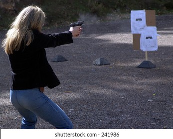 Blond woman at shooting range 2