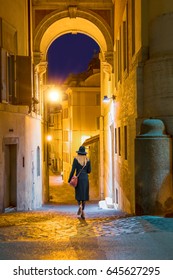 Blond Woman Walking Alone On The Narrow Street At Night