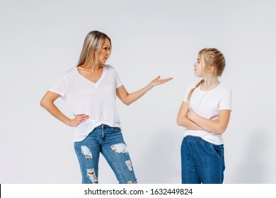 Blonde Angry Mom And Sad Daughter In White T-shirts And Jeans Isolated On The White Background