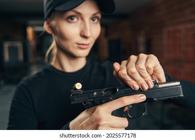 Blonde Attractive Woman Pulling Back The Handgun Slide