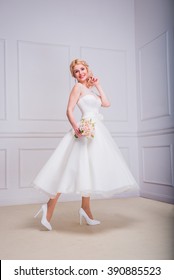 Blonde Beautiful Bride In Short Dress With Wedding Bouquet 