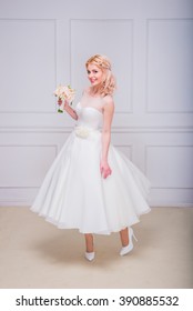 Blonde Beautiful Bride In Short Dress With Wedding Bouquet 