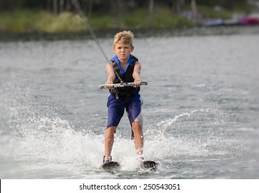 Blonde Boy Learning To Waterski On A Lake