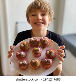 Blonde Boy With Plate Of Easter Cup Cakes.