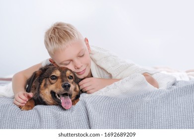 Blonde Boy Sleeping With His Dog In Bed