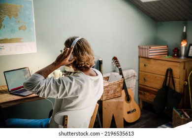 Blonde Bristle Man In Headphones Working With Laptop At Home