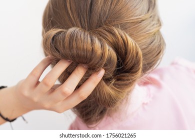 Blonde Bun Close-up. Isolated Against White Background. Pink Dress. Amazing Woman Hair. Caucasian. 