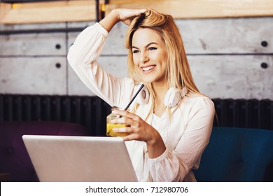Blonde business woman is enjoying in restaurant and fleelance job. - Powered by Shutterstock