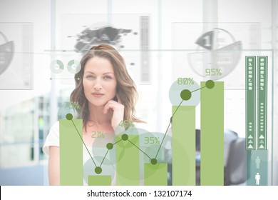 Blonde businesswoman using green chart interface with statistics - Powered by Shutterstock