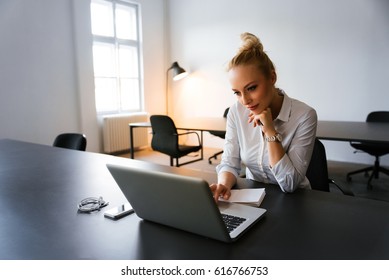 Blonde Bussines Woman Spending Time Next To Lap Top In Her Office