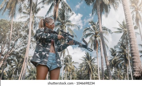 blonde in camo jacket is ready shooting from a crossbow