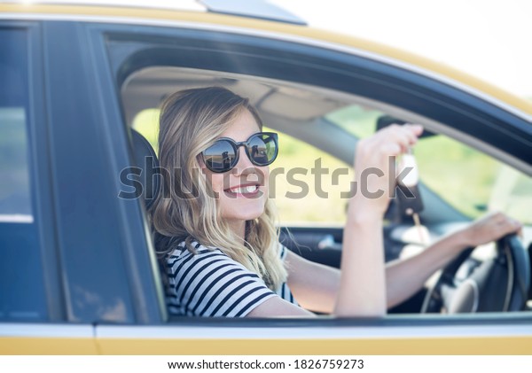 The\
blonde in the car. Attractive woman drives a\
car.