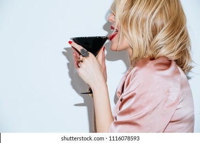 Blonde Caucasian Woman Having Fun On Party Licking Sugar On Cocktail Glass.