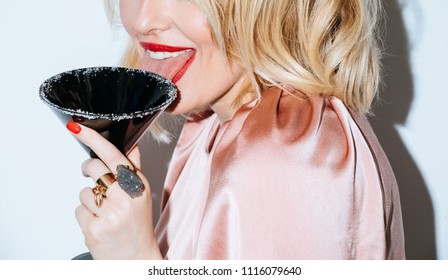 Blonde Caucasian Woman Having Fun On Party Licking Sugar On Cocktail Glass.