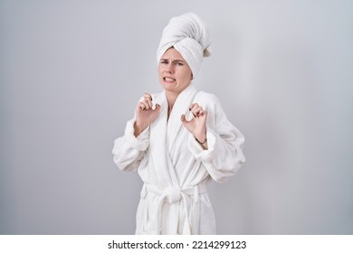 Blonde Caucasian Woman Wearing Bathrobe Disgusted Expression, Displeased And Fearful Doing Disgust Face Because Aversion Reaction. 