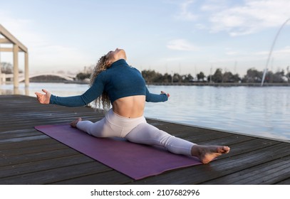 Blonde Curly Hair Woman, Happy Smiling Doing Exercises In The Park, Yoga Teacher, On A Pier At Sunset