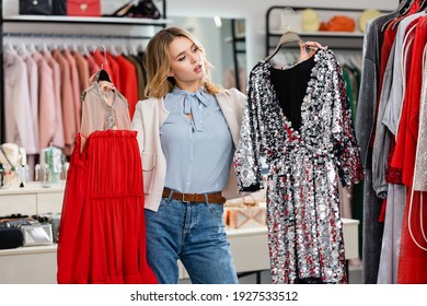 Blonde customer looking at dresses in showroom  - Powered by Shutterstock