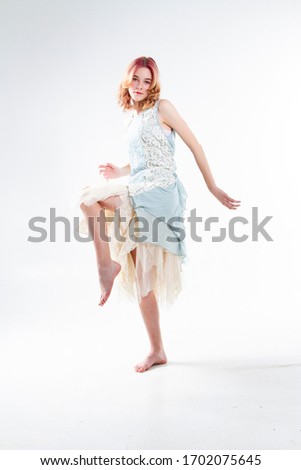 blonde in the dress. Studio portrait on a white background.