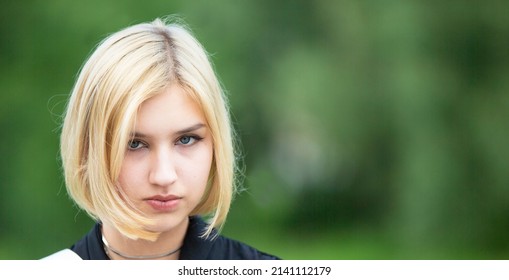 blonde-face-on-green-background-seventeen-stock-photo-2141112179