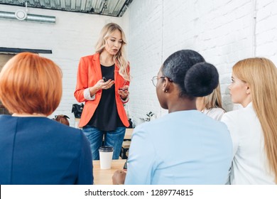 Blonde Female Employee Make Presentation For Diverse Employees During Meeting