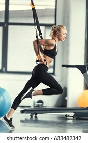 Blonde Fitness Woman Training With Trx Fitness Straps