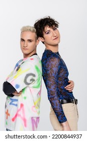 Blonde Gay Man And Brunette Nonbinary Person In Stylish Clothes Standing Back To Back Isolated On Grey