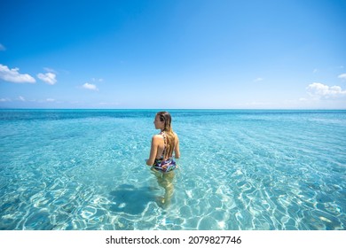 Blonde girl bathing in Stintino beach called "La Pelosa". Stintino, Sassari province, Sardinia, Italy - Shutterstock ID 2079827746