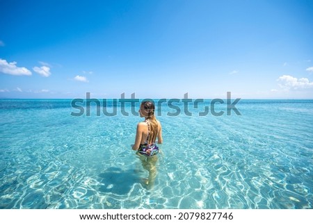 Blonde girl bathing in Stintino beach called 