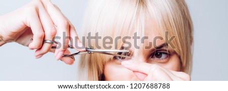 Blonde girl cut forelock. Close up hairstyle with bangs. Hair care concept