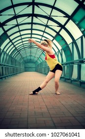 blonde girl with dreadlocks dancing in an empty pedestrian crossing 