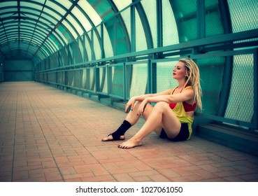 blonde girl with dreadlocks dancing in an empty pedestrian crossing 