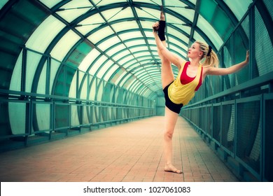 blonde girl with dreadlocks dancing in an empty pedestrian crossing 