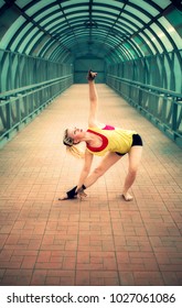 blonde girl with dreadlocks dancing in an empty pedestrian crossing 
