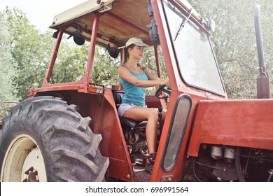 Blonde Girl Driving A Tractor