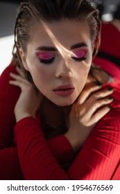 Blonde Girl With Flawless Skin And Highlights On Her Face. Pink Neon Eye Makeup. Closed Eyes. Portrait Of Elegant Beautiful Caucasian Woman. Creative Fashion Portrait