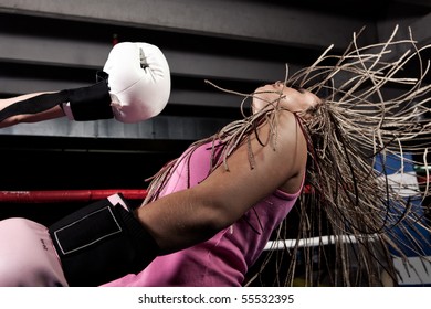 Blonde girl getting knocked out in a boxing ring - Powered by Shutterstock