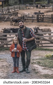 A Blonde Girl And Her Father Holding A Glass Of Organic Milk