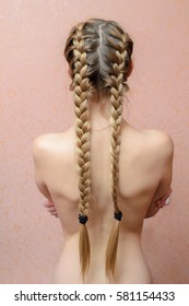 Blonde Girl With The Naked Back And Long Hair Braided