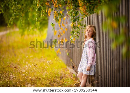 Similar – Foto Bild Herbstportrait eines glücklichen Kindes Mädchens im Garten sitzend