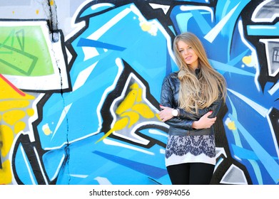 Blonde Girl Smiling Against Grafitti Wall