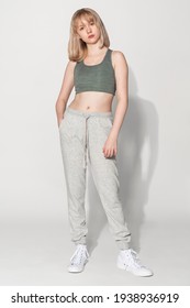 Blonde girl in sports bra and sweatpants activewear photoshoot - Shutterstock ID 1938936919