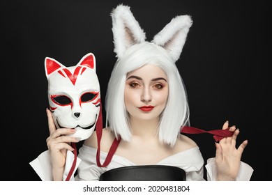 Blonde Girl In A Wig On A Black Background With Cosplay Mask, Cat Women.